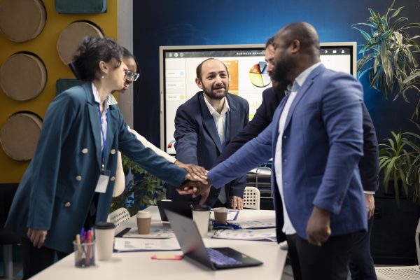 Company personnel coming together to honor a well done effort, attending an evaluation meeting and being satisfied with their conclusions. Operations employees unite forces for success.