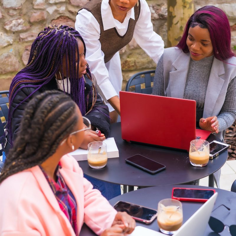 Young businesswomen of black ethnicity. At a business meeting in a cafeteria. Teamwork